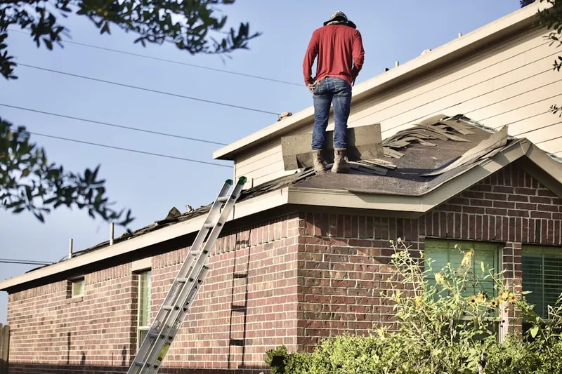 Professional roofer working on a residential roof in Ten Hills